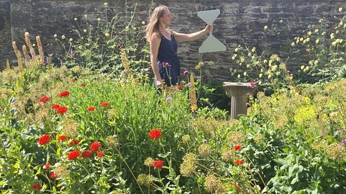 A woman standing in a flower garden